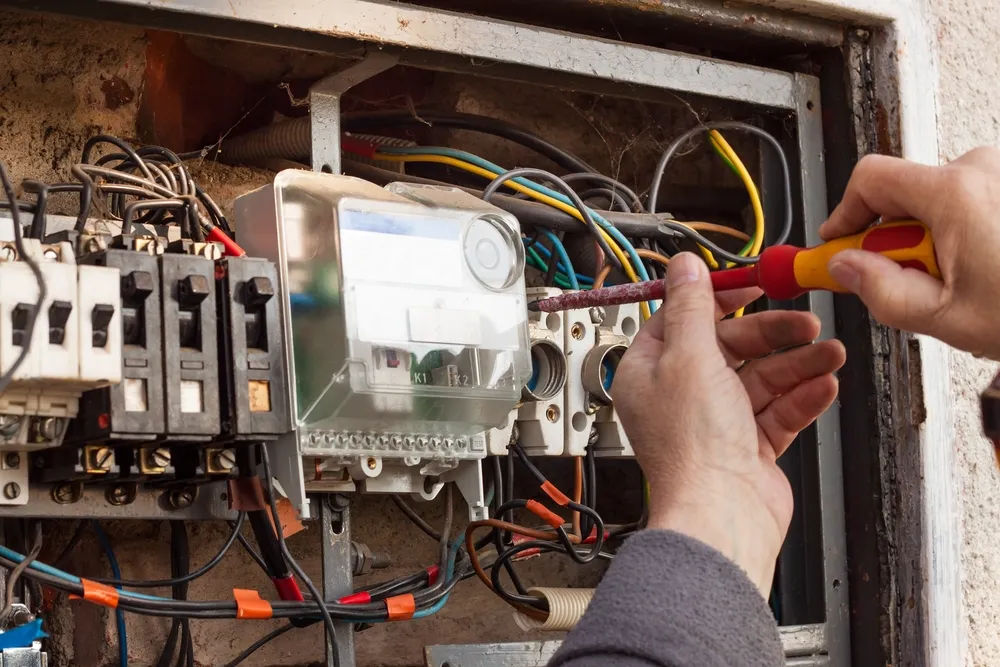Old ceramic fuse box being replaced by a Hills District electrician