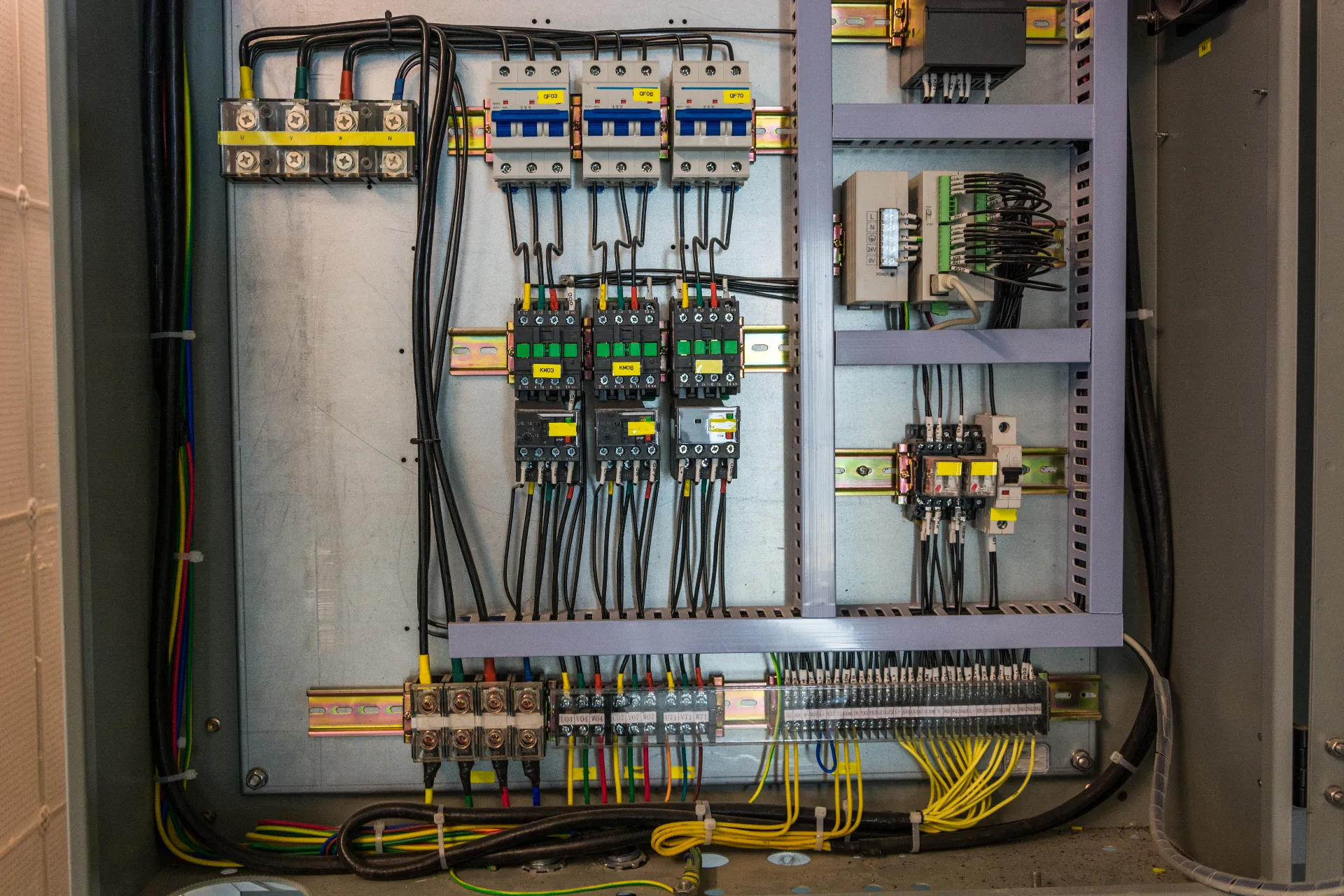 Commercial electrician installing LED lighting and dedicated circuits inside a Hills District office